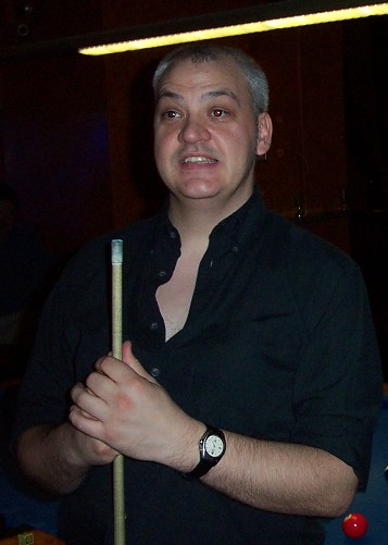 Smiling, holding a cue and looking at the camera was just too much at the same time.